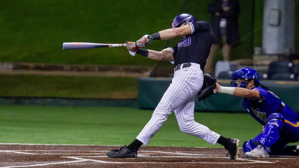 Bryce Johnson finishing a swing in a night game